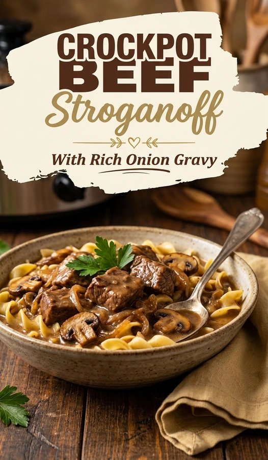 Slow cooker beef stroganoff with tender beef chunks and mushrooms in a creamy onion gravy over wide egg noodles.