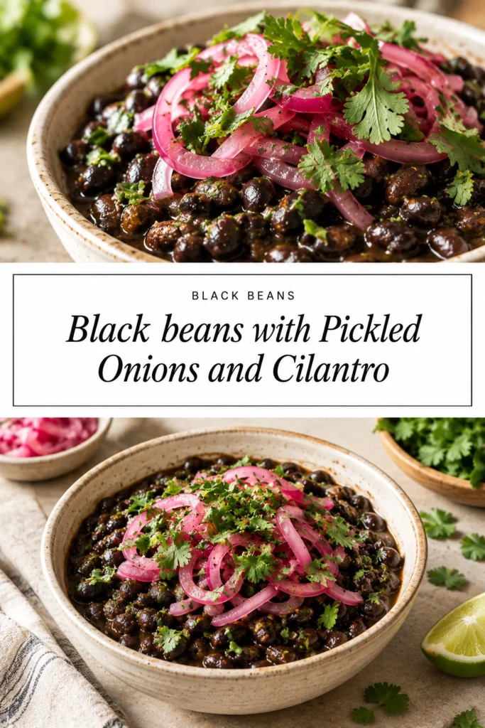 A bowl of seasoned black beans topped with bright pink pickled onions and fresh green cilantro leaves.