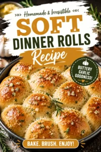 Golden brown soft dinner rolls topped with melted garlic butter and fresh rosemary sprigs in a baking pan.